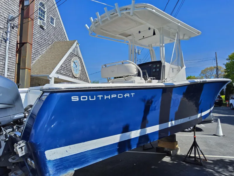 Slide: The Image of 2007 Southport 26 Center Console boat with blue hull, docked outdoors. - 5