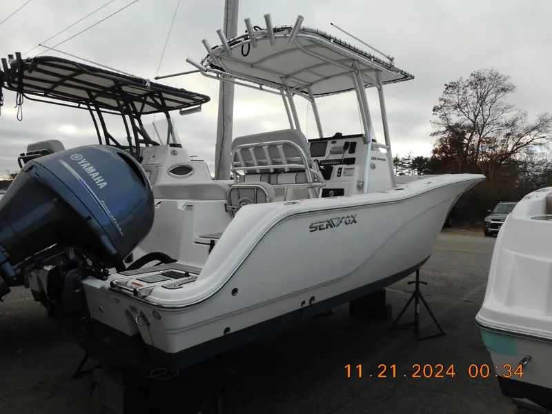 Slide: The Image of 2023 Sea Fox 228 Commander boat with Yamaha engine, parked outdoors. - 4