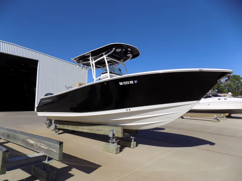 Slide: The Image of 2017 Sportsman Heritage 251 Center Console boat on display outside a warehouse. - 0
