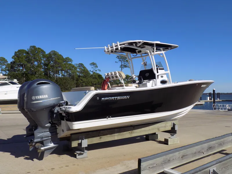 Slide: The Image of 2017 Sportsman Heritage 251 Center Console boat with Yamaha engine on dock. - 1