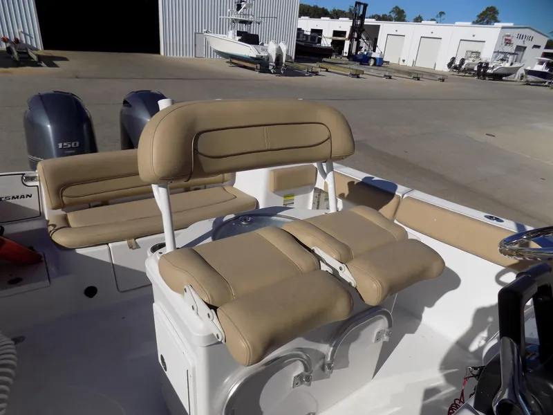 Slide: The Image of 2017 Sportsman Heritage 251 Center Console boat interior with tan seating and dual engines. - 12