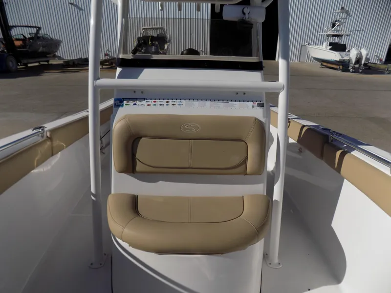 Slide: The Image of 2017 Sportsman Heritage 251 Center Console boat interior with tan seating. - 14