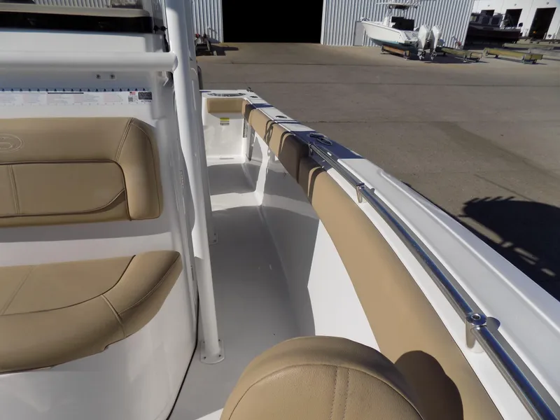 Slide: The Image of 2017 Sportsman Heritage 251 Center Console boat interior with tan seating. - 16