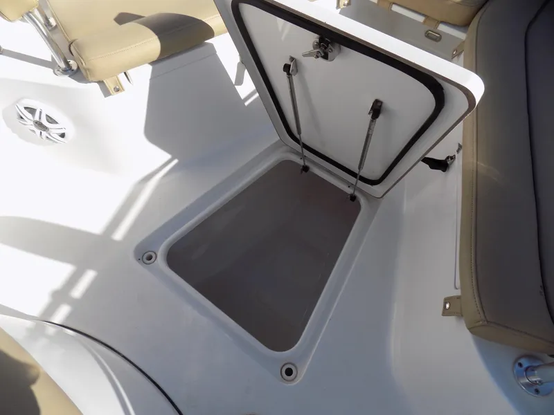 Slide: The Image of Open storage compartment on 2017 Sportsman Heritage 251 Center Console boat. - 17