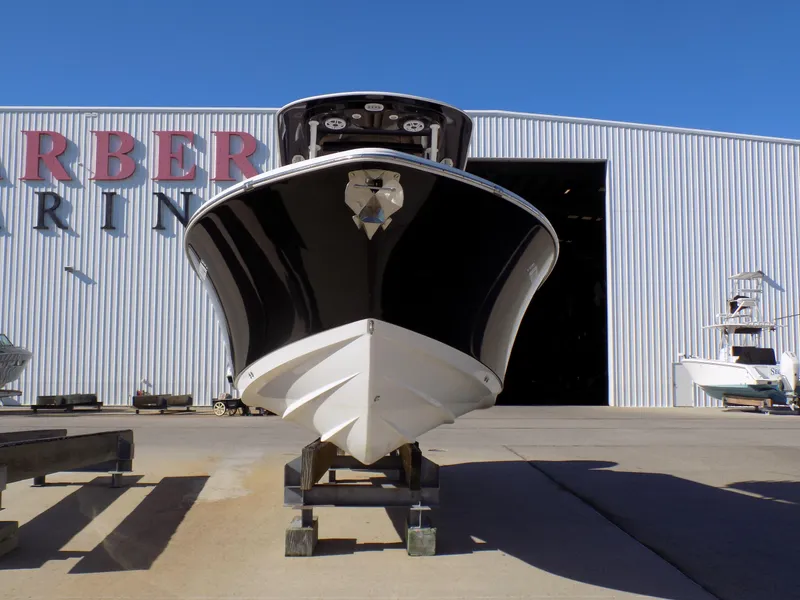 Slide: The Image of 2017 Sportsman Heritage 251 Center Console boat in front of a marina building. - 3