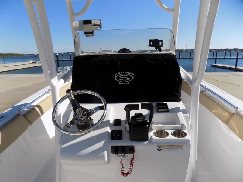 Slide: The Image of 2017 Sportsman Heritage 251 Center Console boat dashboard with steering wheel and controls. - 8