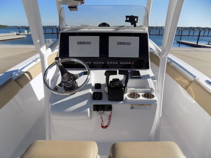 Slide: The Image of 2017 Sportsman Heritage 251 Center Console boat dashboard with dual Simrad displays. - 9