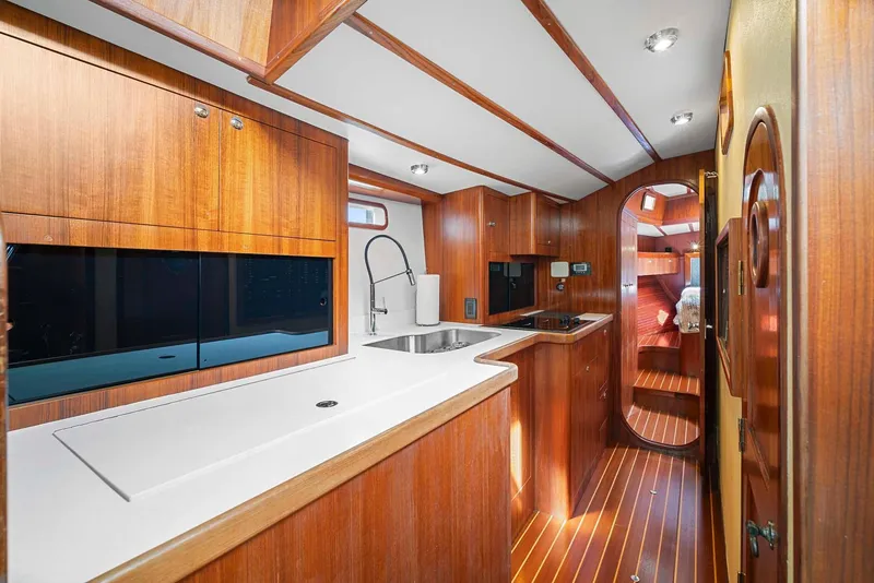 Slide: The Image of 1981 Pearson 530 yacht interior with wooden cabinetry and modern kitchen amenities. - 11