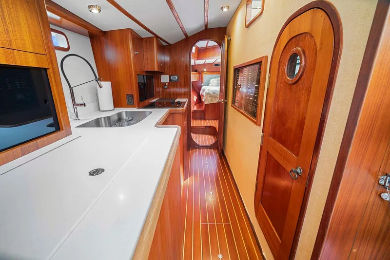 Slide: The Image of Interior of 1981 Pearson 530 yacht with wooden finishes and modern kitchen. - 12