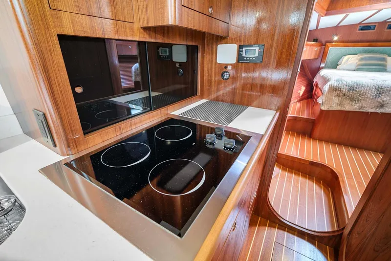 Slide: The Image of Pearson 530 yacht interior, 1981 model, featuring a modern kitchen and cozy bedroom. - 14