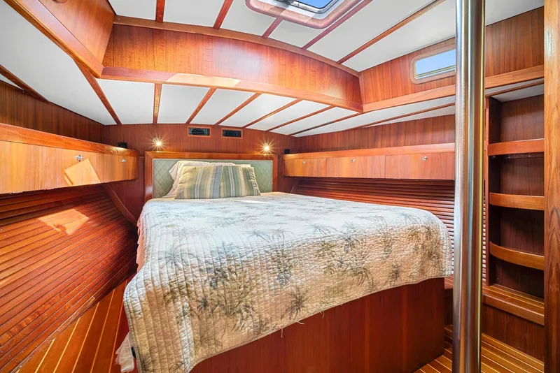 Slide: The Image of Cozy cabin interior of 1981 Pearson 530 sailboat with wood paneling and comfortable bedding. - 17
