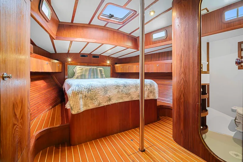 Slide: The Image of Luxurious 1981 Pearson 530 yacht interior with wood paneling and cozy bed. - 18
