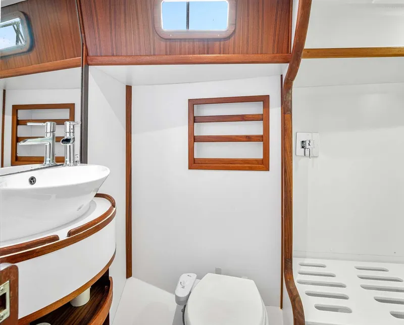 Slide: The Image of 1981 Pearson 530 yacht bathroom with modern sink, toilet, and wooden accents. - 20