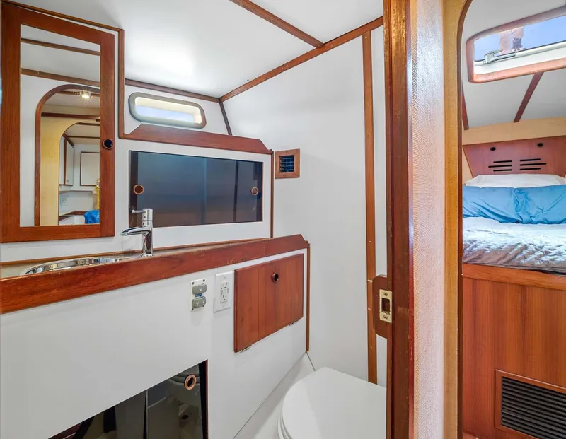 Slide: The Image of Interior of 1981 Pearson 530 yacht showing bathroom and adjacent sleeping area. - 24