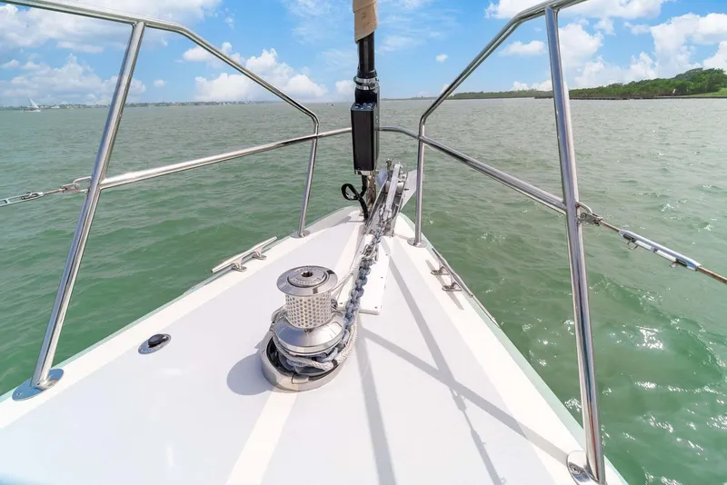 Slide: The Image of Bow of 1981 Pearson 530 sailboat on open water under blue sky. - 33