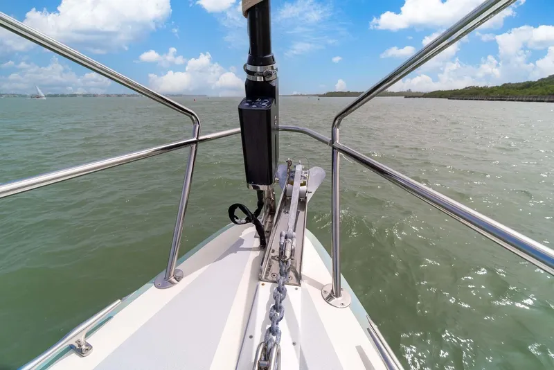 Slide: The Image of Bow of 1981 Pearson 530 sailboat on calm waters under blue sky. - 34
