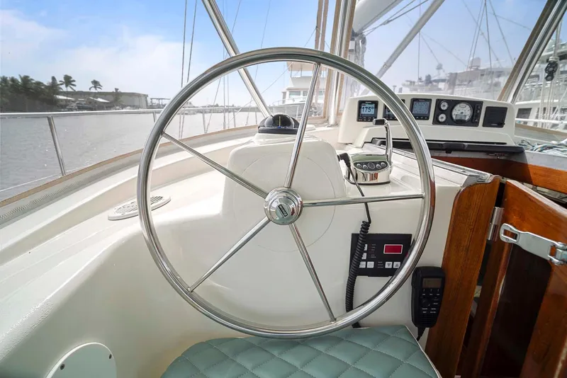 Slide: The Image of Steering wheel of a 1981 Pearson 530 sailboat with navigation instruments. - 41