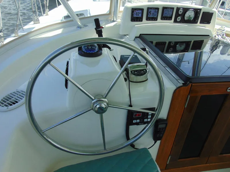 Slide: The Image of 1981 Pearson 530 yacht helm with steering wheel and navigation instruments. - 42