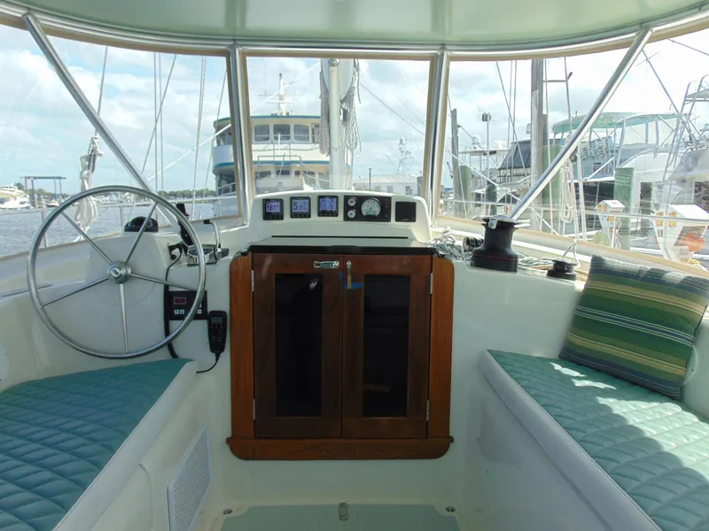 Slide: The Image of Interior view of 1981 Pearson 530 sailboat cockpit with steering wheel and seating. - 43
