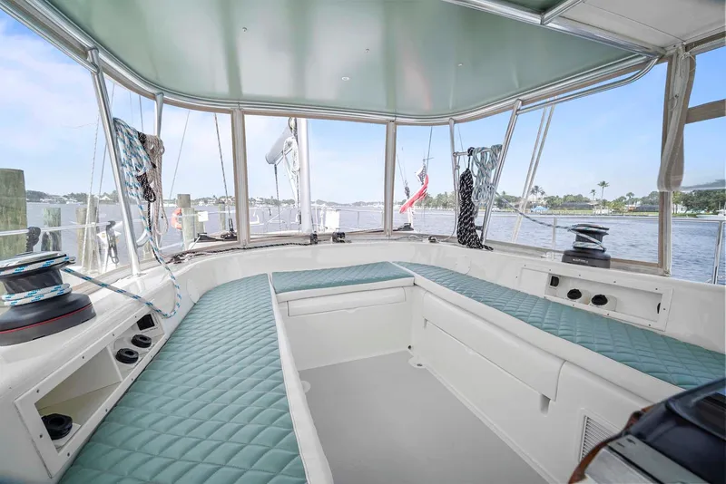 Slide: The Image of Spacious interior of 1981 Pearson 530 yacht with panoramic windows and cushioned seating. - 46