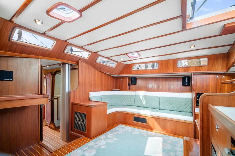 Slide: The Image of Interior of 1981 Pearson 530 yacht with wood paneling and cushioned seating. - 8