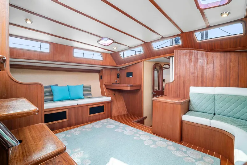 Slide: The Image of Interior of 1981 Pearson 530 sailboat with wood paneling and cozy seating. - 9