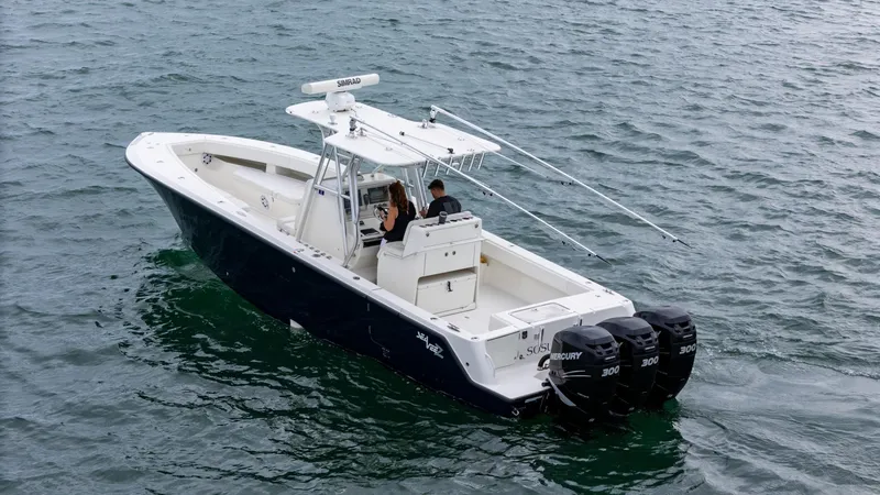 Slide: The Image of 2015 SeaVee 340Z boat with triple Mercury engines on open water. - 1