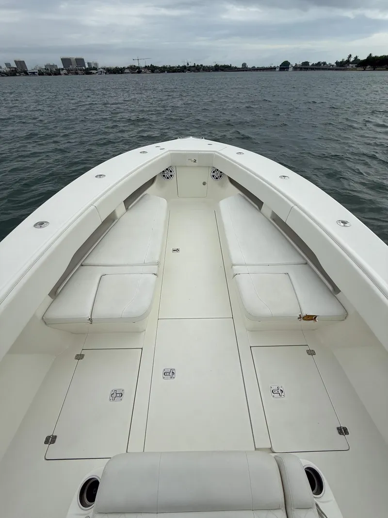 Slide: The Image of 2015 SeaVee 340Z boat with spacious deck and seating on calm water. - 12