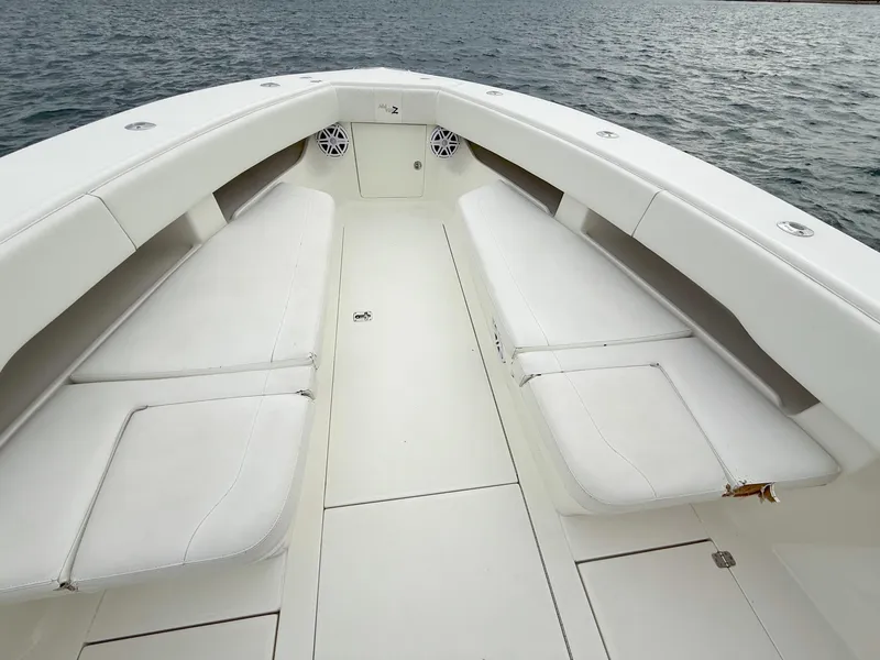 Slide: The Image of 2015 SeaVee 340Z boat interior with white cushioned seating on calm water. - 14