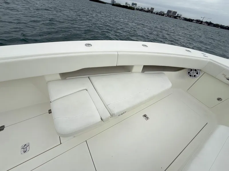 Slide: The Image of 2015 SeaVee 340Z boat interior with cushioned seating, on calm water. - 15