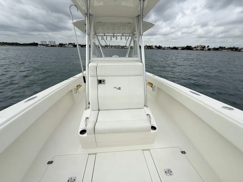 Slide: The Image of 2015 SeaVee 340Z boat on water, featuring spacious deck and seating. - 18