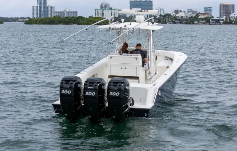 Slide: The Image of 2015 SeaVee 340Z boat with triple 300 horsepower engines on the water. - 2