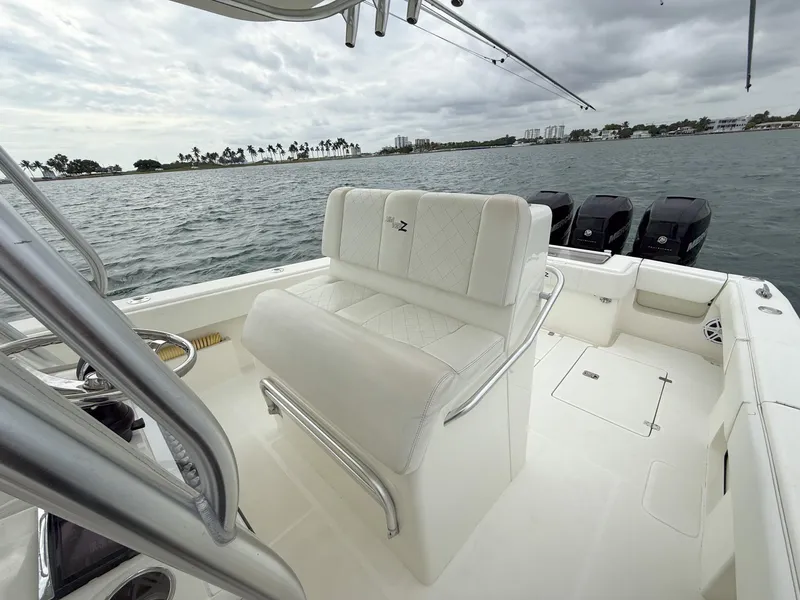 Slide: The Image of 2015 SeaVee 340Z boat interior with seating, ocean view, and triple outboard motors. - 20