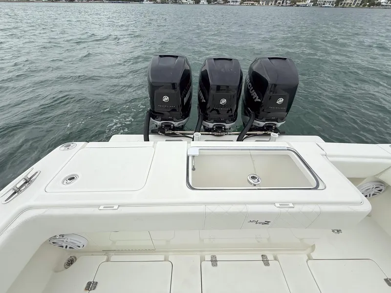 Slide: The Image of 2015 SeaVee 340Z boat with triple outboard engines on open water. - 23