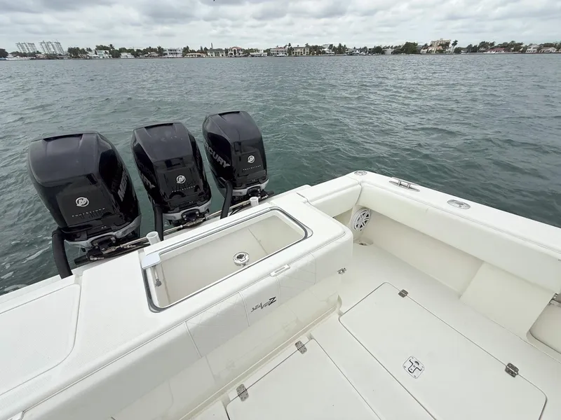 Slide: The Image of 2015 SeaVee 340Z boat with triple outboard engines on calm water. - 24