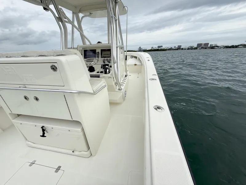 Slide: The Image of 2015 SeaVee 340Z boat on water, featuring spacious deck and modern controls. - 27
