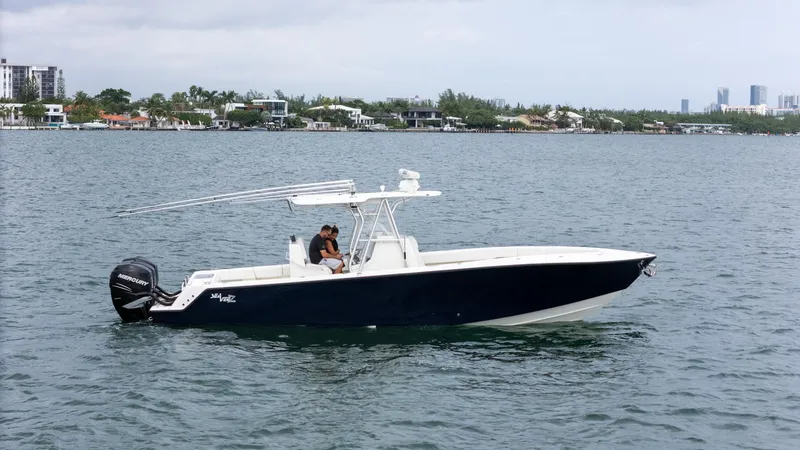 Slide: The Image of 2015 SeaVee 340Z boat on calm water with cityscape background. - 3