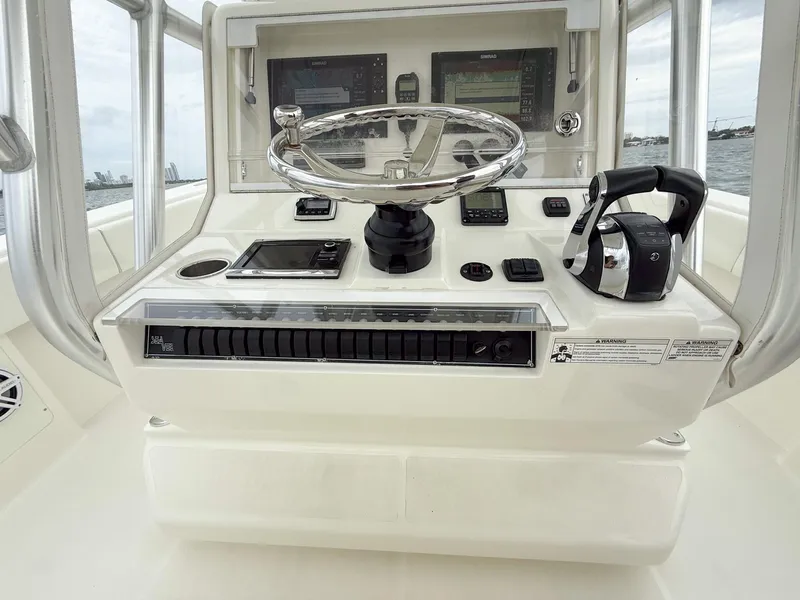 Slide: The Image of 2015 SeaVee 340Z boat helm with steering wheel and navigation controls. - 30