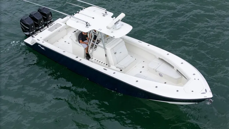 Slide: The Image of 2015 SeaVee 340Z boat on water, featuring triple outboard engines. - 6