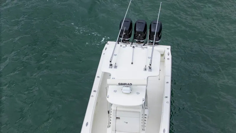 Slide: The Image of 2015 SeaVee 340Z boat with triple outboard engines on open water. - 7