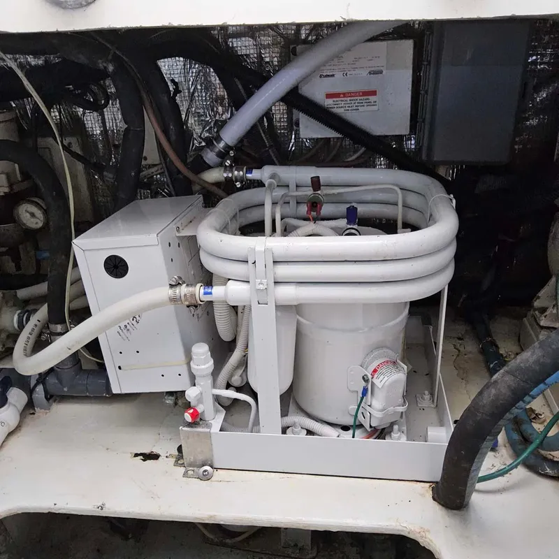 Slide: The Image of Engine room of 2000 Ocean Yachts Super Sport with mechanical equipment and piping. - 15