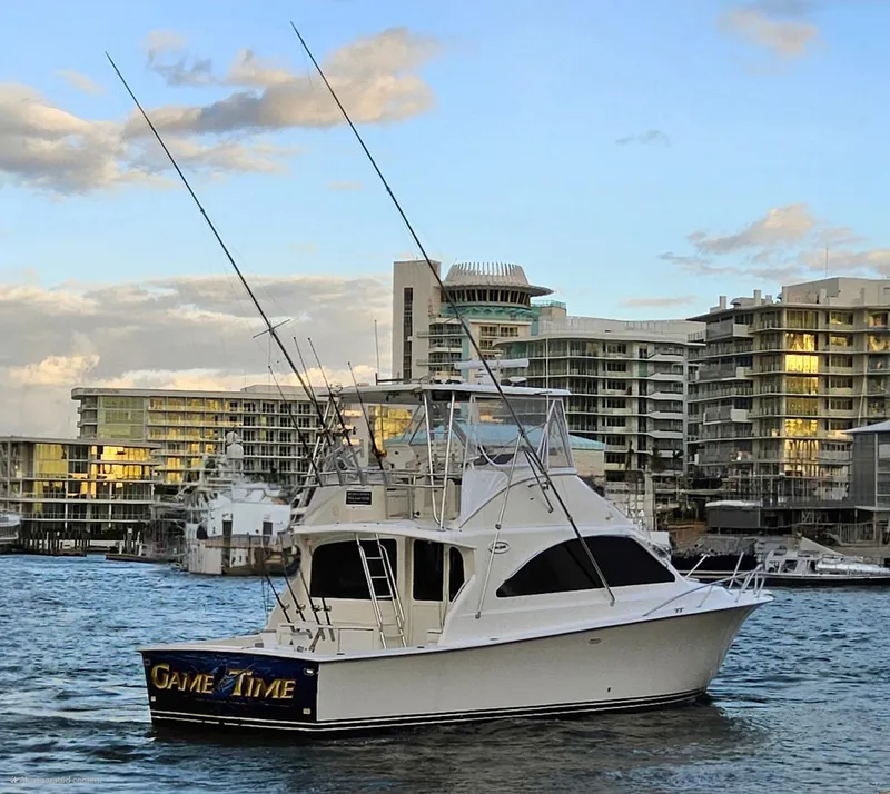 Slide: The Image of Ocean Yachts 2000 Super Sport boat in marina, cityscape background, evening light. - 18