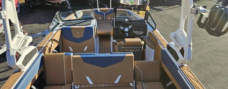 Slide: The Image of 2025 Nautique Super Air Nautique GS22 boat interior with modern seating and dashboard design. - 10