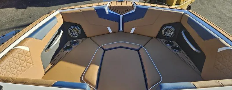 Slide: The Image of 2025 Nautique Super Air Nautique GS22 boat interior with tan and blue seating. - 7