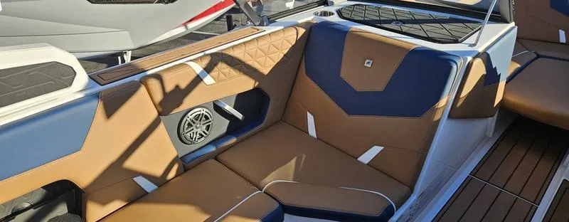 Slide: The Image of 2025 Nautique Super Air Nautique GS22 interior with tan and blue seating. - 9