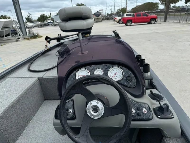Slide: The Image of 2018 Tracker Pro 170 boat dashboard with steering wheel and gauges. - 11