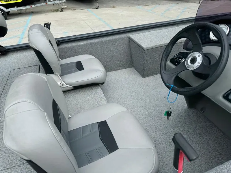 Slide: The Image of 2018 Tracker Pro 170 boat interior with gray seating and steering wheel. - 12
