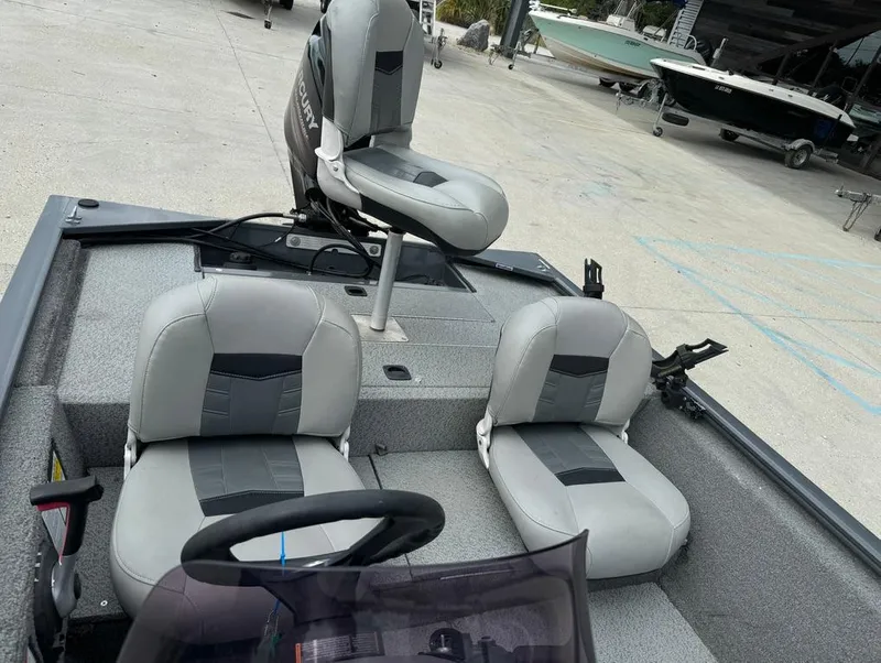 Slide: The Image of 2018 Tracker Pro 170 boat interior with three gray seats. - 13