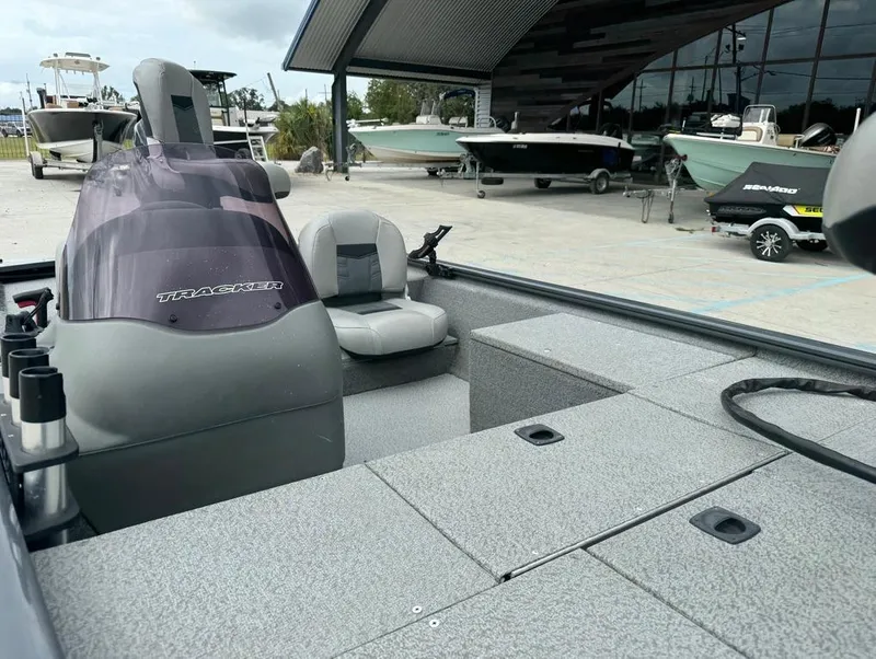 Slide: The Image of 2018 Tracker Pro 170 boat interior at a marina with other boats in the background. - 16