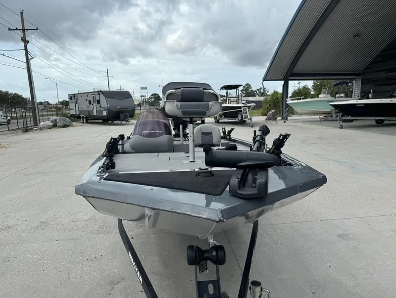Slide: The Image of 2018 Tracker Pro 170 boat parked outdoors near other vehicles. - 4